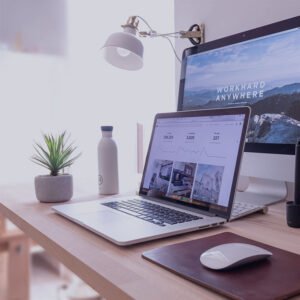 laptop and desktop on top of a table